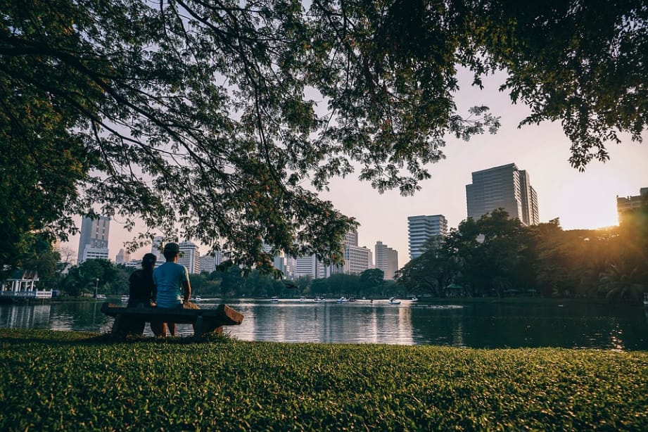 a couple sitting by the lake